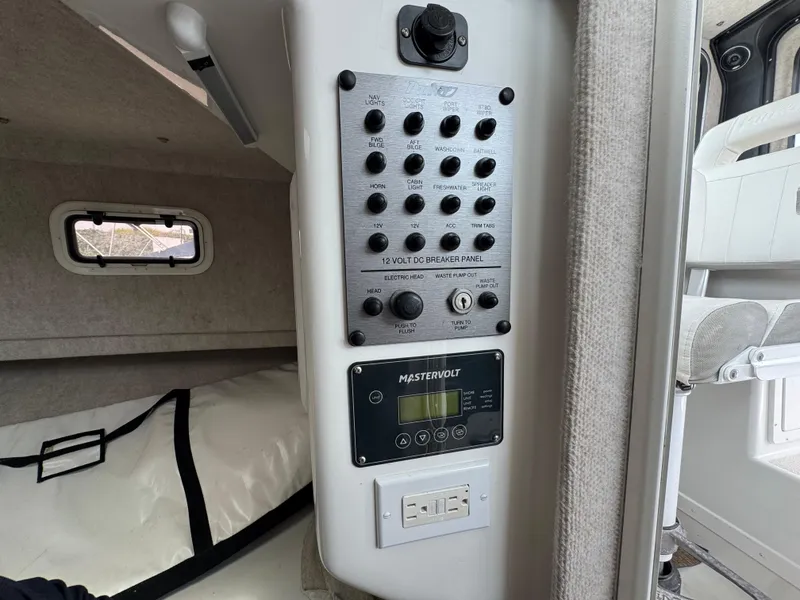 Slide: The Image of Control panel inside 2021 Parker 2520 XLD Sport Cabin boat, featuring Mastervolt system. - 13