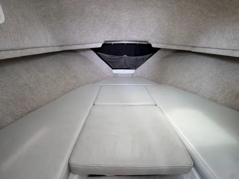 Slide: The Image of Interior cabin of 2021 Parker 2520 XLD Sport Cabin boat, featuring cushioned seating. - 14