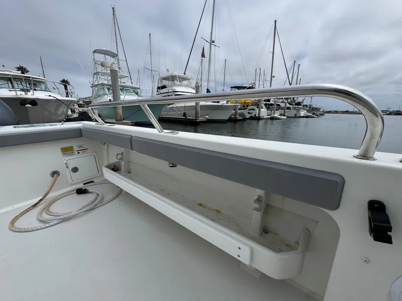 Slide: The Image of 2021 Parker 2520 XLD Sport Cabin boat docked at marina with other vessels. - 15