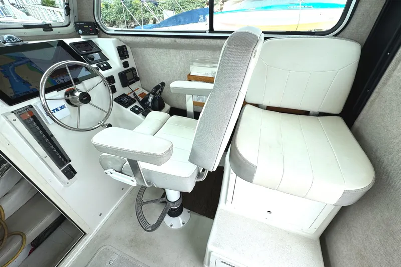 Slide: The Image of Interior of 2021 Parker 2520 XLD Sport Cabin with steering wheel and seating. - 17