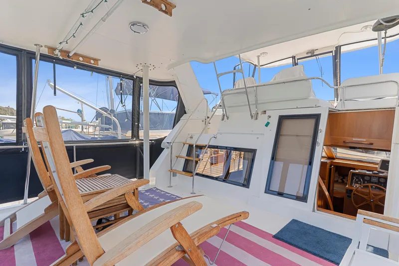 Slide: The Image of Interior view of 1993 Ocean Alexander 440 yacht with wooden chairs and nautical decor. - 11
