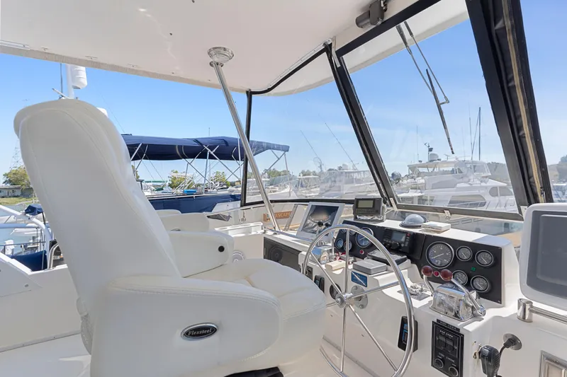 Slide: The Image of Interior view of 1993 Ocean Alexander 440 yacht helm with steering wheel and controls. - 12