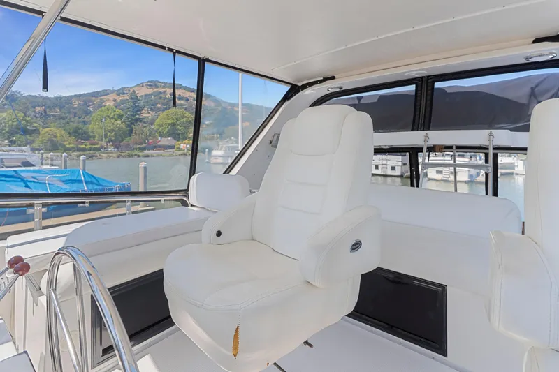Slide: The Image of Interior of 1993 Ocean Alexander 440 yacht with white captain's chair and scenic marina view. - 14