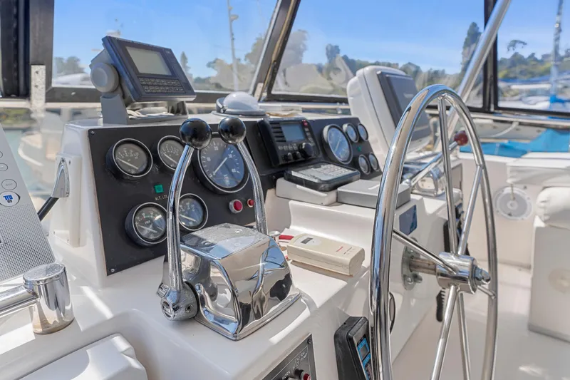Slide: The Image of Cockpit of 1993 Ocean Alexander 440 yacht with steering wheel and navigation instruments. - 15