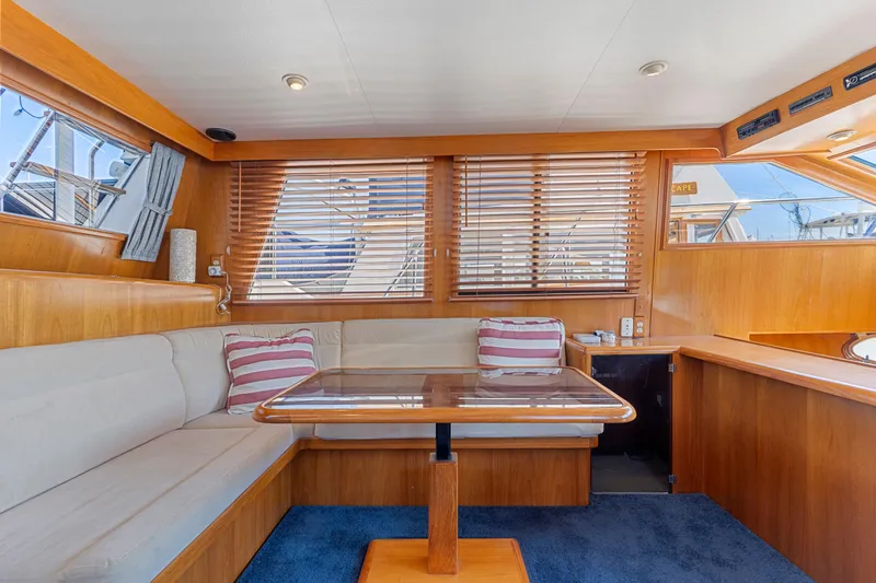 Slide: The Image of Interior of 1993 Ocean Alexander 440 yacht with wooden accents and cozy seating area. - 16
