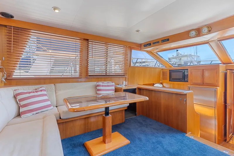 Slide: The Image of Luxurious 1993 Ocean Alexander 440 yacht interior with wood accents and comfortable seating. - 17