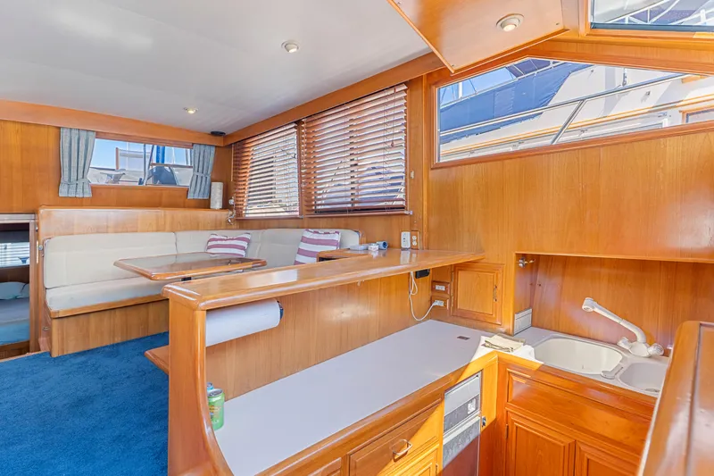 Slide: The Image of Luxurious 1993 Ocean Alexander 440 yacht interior with wood finish and cozy seating area. - 23