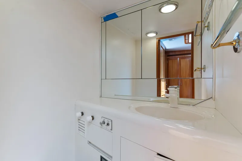 Slide: The Image of Bathroom interior of 1993 Ocean Alexander 440 yacht, featuring a sink and mirrored cabinet. - 26