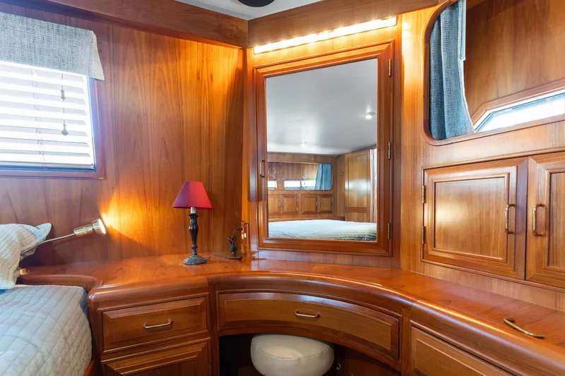 Slide: The Image of Luxurious wooden interior of 1993 Ocean Alexander 440 yacht cabin with mirror and lamp. - 29