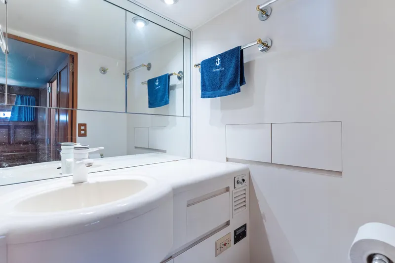 Slide: The Image of Bathroom interior of 1993 Ocean Alexander 440 yacht with mirror and blue towel. - 30