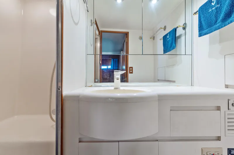 Slide: The Image of Bathroom interior of 1993 Ocean Alexander 440 yacht with modern fixtures and blue towels. - 31