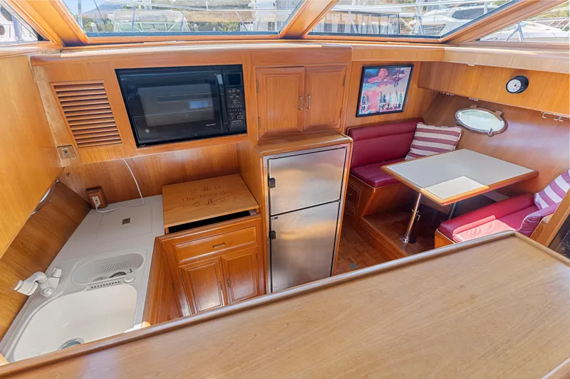 Slide: The Image of Interior of 1993 Ocean Alexander 440 yacht with kitchenette and dining area. - 35