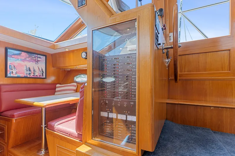 Slide: The Image of 1993 Ocean Alexander 440 yacht interior with wood paneling and red seating. - 36