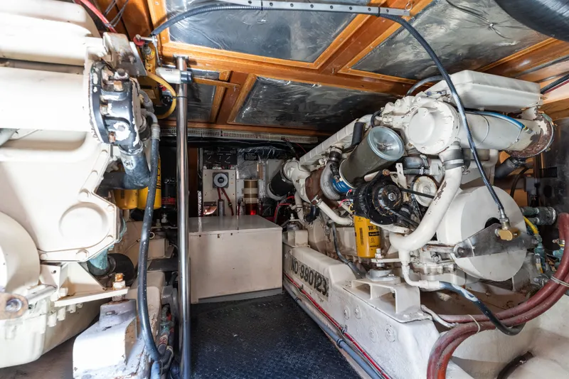 Slide: The Image of Engine room of a 1993 Ocean Alexander 440 yacht, showcasing detailed machinery and components. - 37