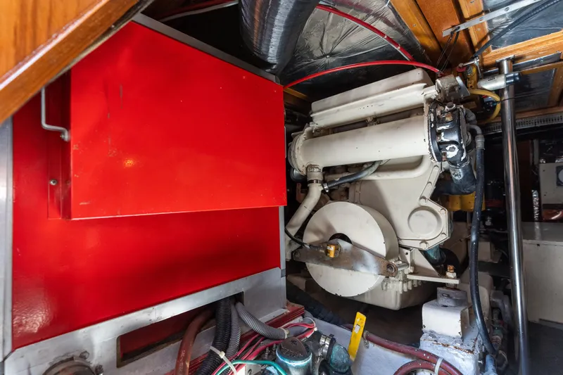 Slide: The Image of Engine room of 1993 Ocean Alexander 440 yacht, featuring machinery and red panel. - 38