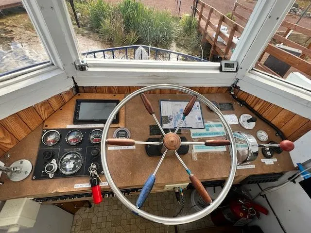 Slide: The Image of 1984 Skipperliner 54 docked on a serene lake with autumn foliage. - 2