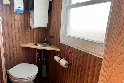 Slide: The Image of Interior of 1984 Skipperliner 54 with wood paneling and cabinetry. - 7