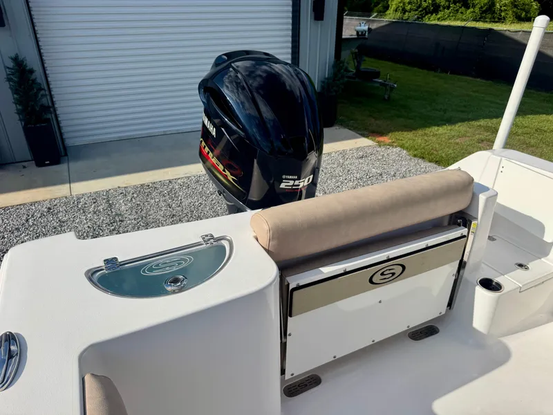 Slide: The Image of 2020 Sportsman Open 232 Center Console boat with Yamaha 250 engine, docked near a garage. - 12