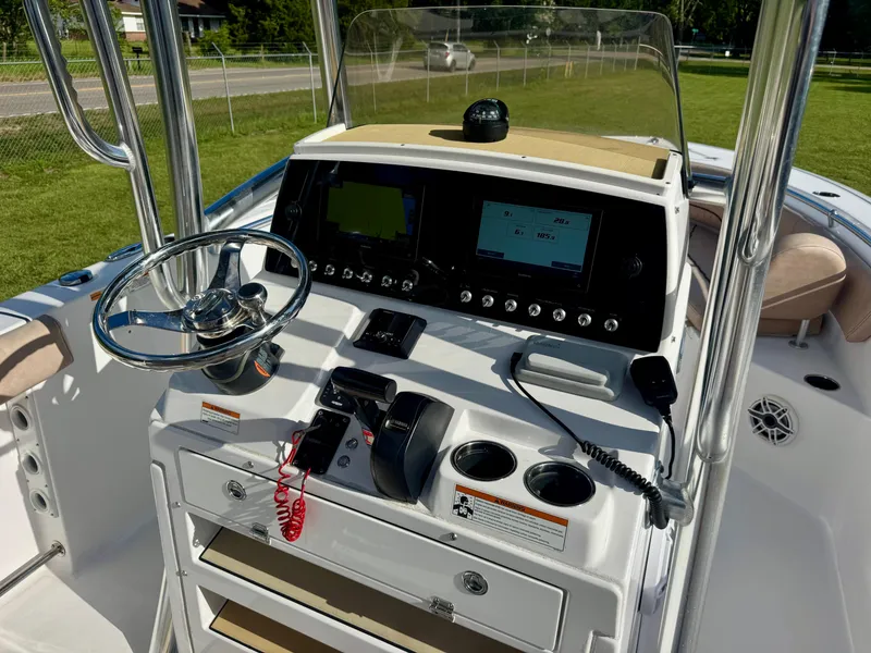 Slide: The Image of 2020 Sportsman Open 232 Center Console boat dashboard with steering wheel and navigation display. - 14