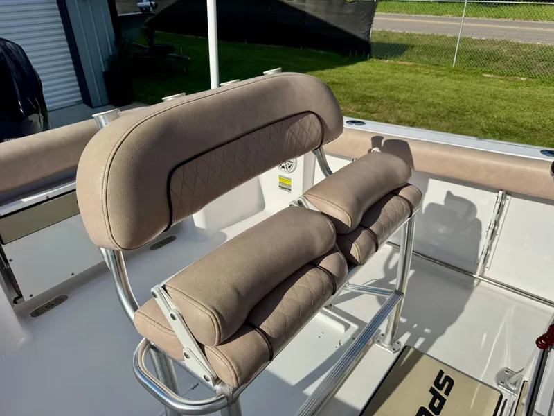 Slide: The Image of 2020 Sportsman Open 232 Center Console boat seating with beige cushions and stainless steel frame. - 18