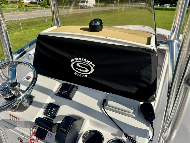 Slide: The Image of 2020 Sportsman Open 232 Center Console boat dashboard with steering wheel and navigation equipment. - 20