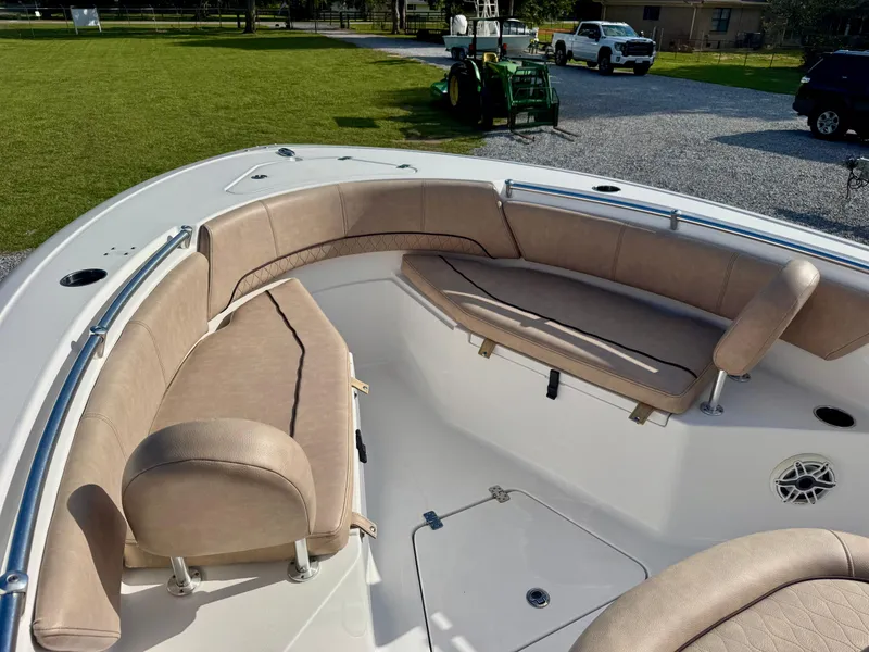 Slide: The Image of 2020 Sportsman Open 232 Center Console boat with beige seating and spacious deck. - 7