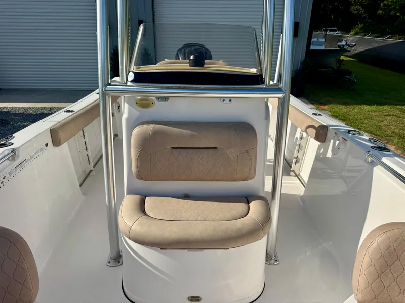 Slide: The Image of 2020 Sportsman Open 232 Center Console boat interior with beige seating and console. - 8