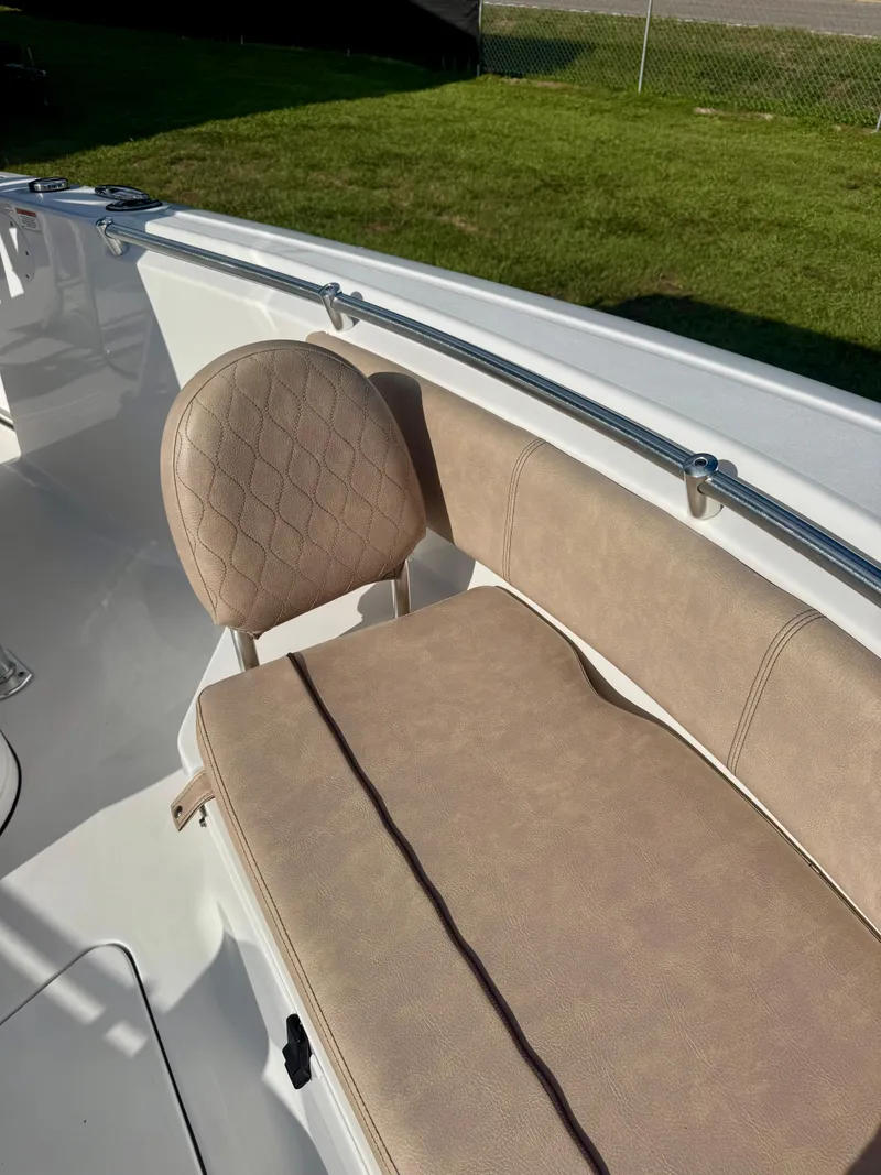 Slide: The Image of 2020 Sportsman Open 232 Center Console boat with beige seating and stainless steel railing. - 9