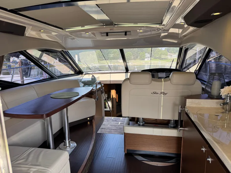 Slide: The Image of Luxurious interior of 2014 Sea Ray 510 Sundancer yacht with elegant seating and dining area. - 12