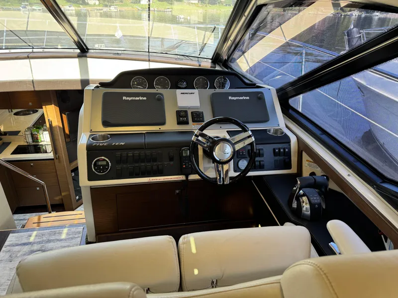 Slide: The Image of Luxurious helm of 2014 Sea Ray 510 Sundancer yacht with modern controls and steering wheel. - 13