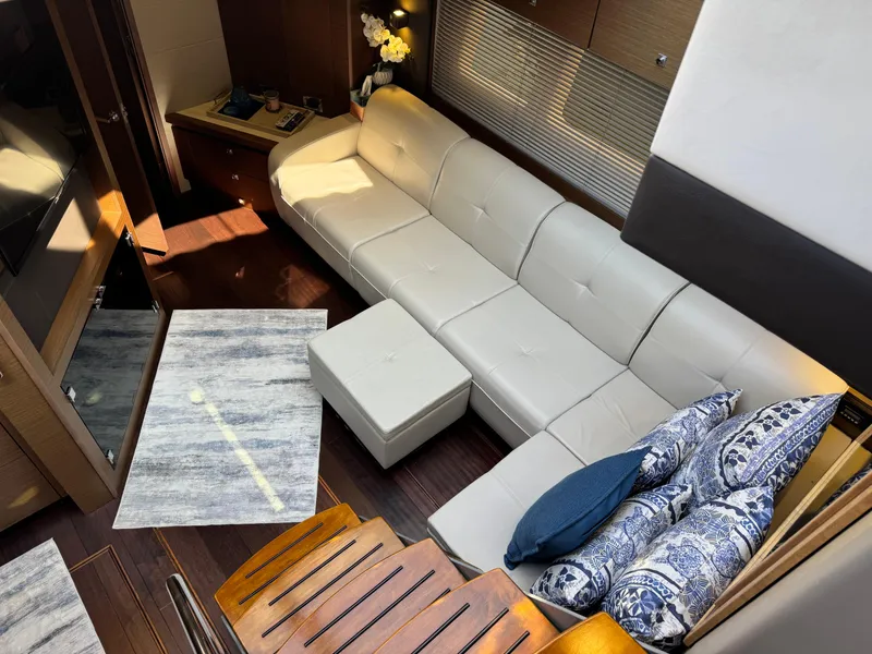 Slide: The Image of Luxurious interior of 2014 Sea Ray 510 Sundancer with white leather seating and decorative pillows. - 15