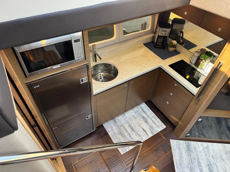 Slide: The Image of Luxurious 2014 Sea Ray 510 Sundancer yacht kitchen with modern appliances and sleek design. - 16