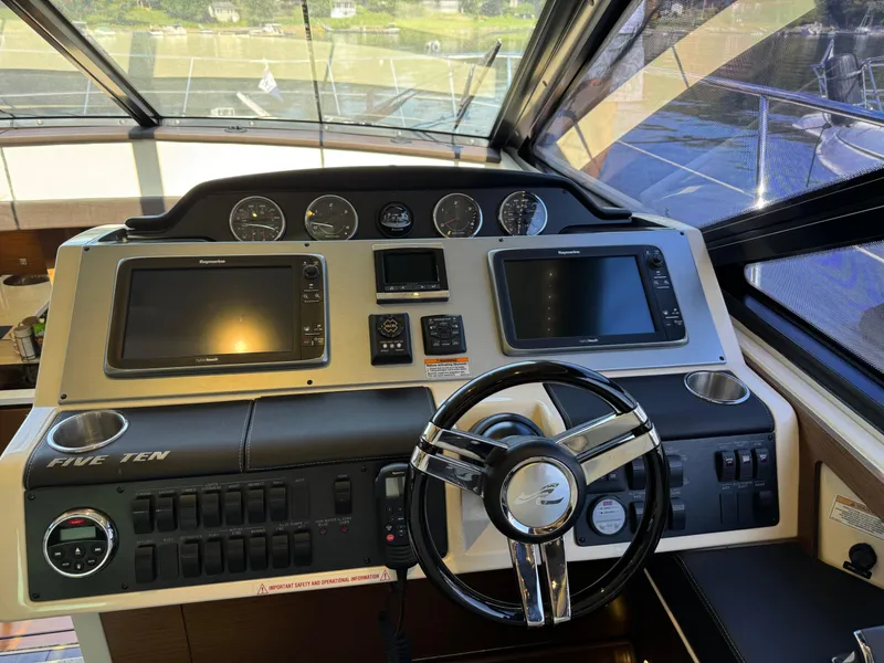 Slide: The Image of Helm of 2014 Sea Ray 510 Sundancer with dual displays and modern controls. - 17