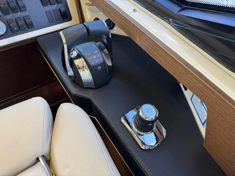 Slide: The Image of Control panel of 2014 Sea Ray 510 Sundancer yacht with throttle and joystick. - 19