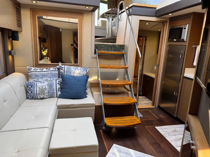 Slide: The Image of Luxurious interior of 2014 Sea Ray 510 Sundancer yacht with elegant seating and wooden stairs. - 26