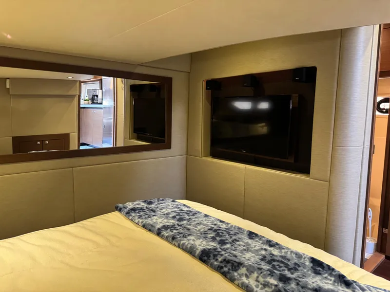 Slide: The Image of Luxurious interior of 2014 Sea Ray 510 Sundancer yacht with TV and cozy bedding. - 32