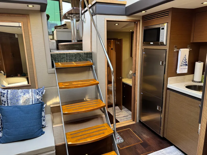 Slide: The Image of Interior of 2014 Sea Ray 510 Sundancer yacht with modern kitchen and wooden stairs. - 33