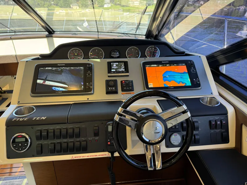 Slide: The Image of Helm of 2014 Sea Ray 510 Sundancer with navigation screens and controls. - 34