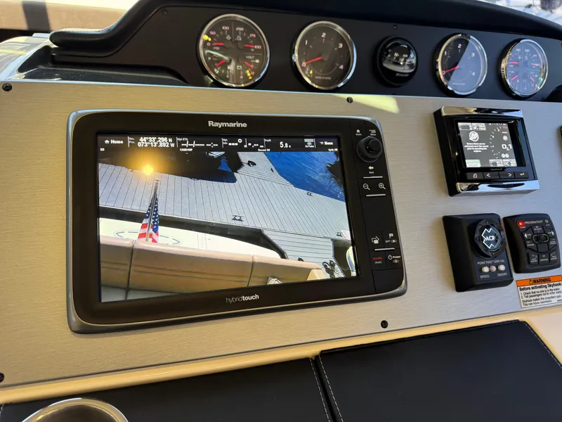 Slide: The Image of Helm of 2014 Sea Ray 510 Sundancer with Raymarine navigation display and control panel. - 35