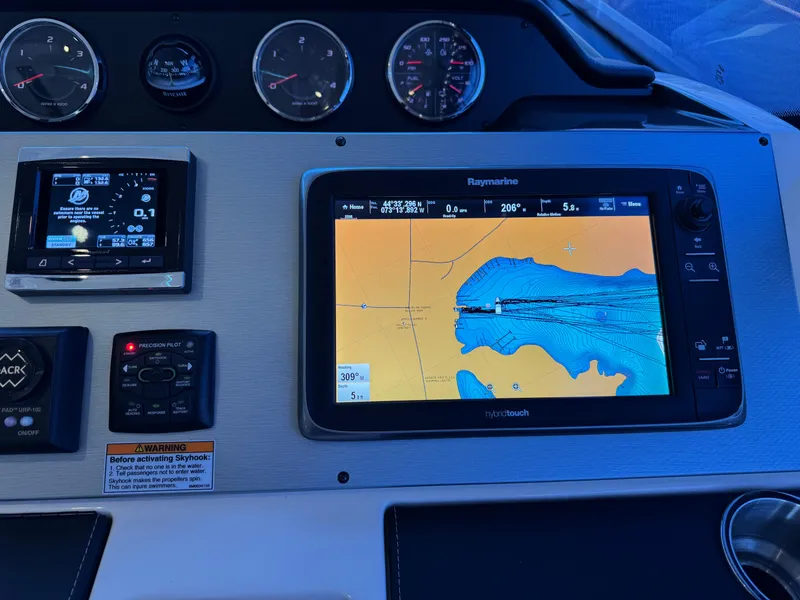 Slide: The Image of Dashboard of a 2014 Sea Ray 510 Sundancer with navigation and control systems. - 36