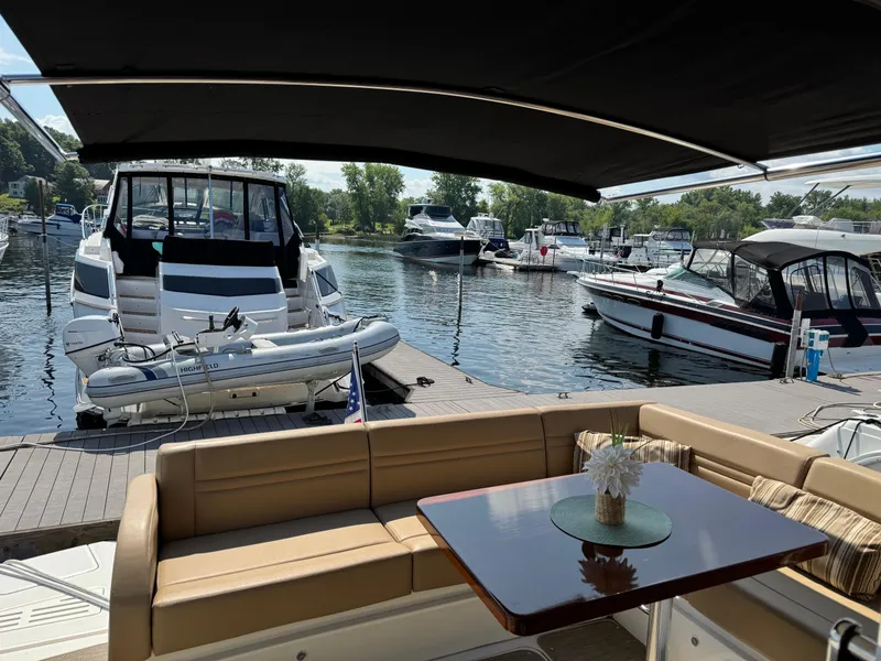 Slide: The Image of Luxurious 2014 Sea Ray 510 Sundancer yacht docked, featuring elegant seating and scenic marina view. - 39