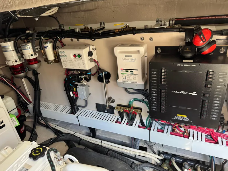 Slide: The Image of Engine room of a 2014 Sea Ray 510 Sundancer with electrical panels and wiring. - 41