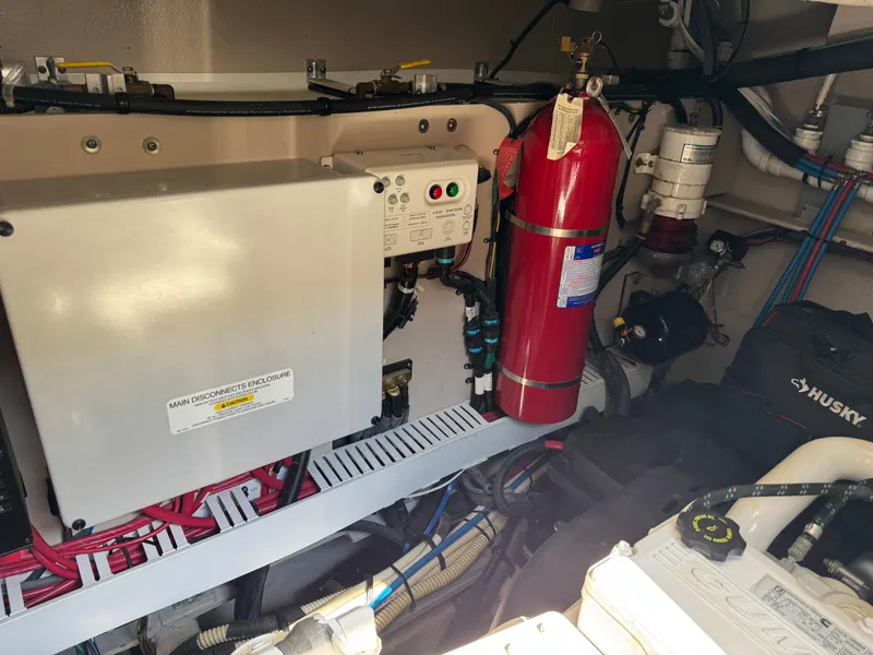 Slide: The Image of Engine room of 2014 Sea Ray 510 Sundancer with fire extinguisher and electrical components. - 43