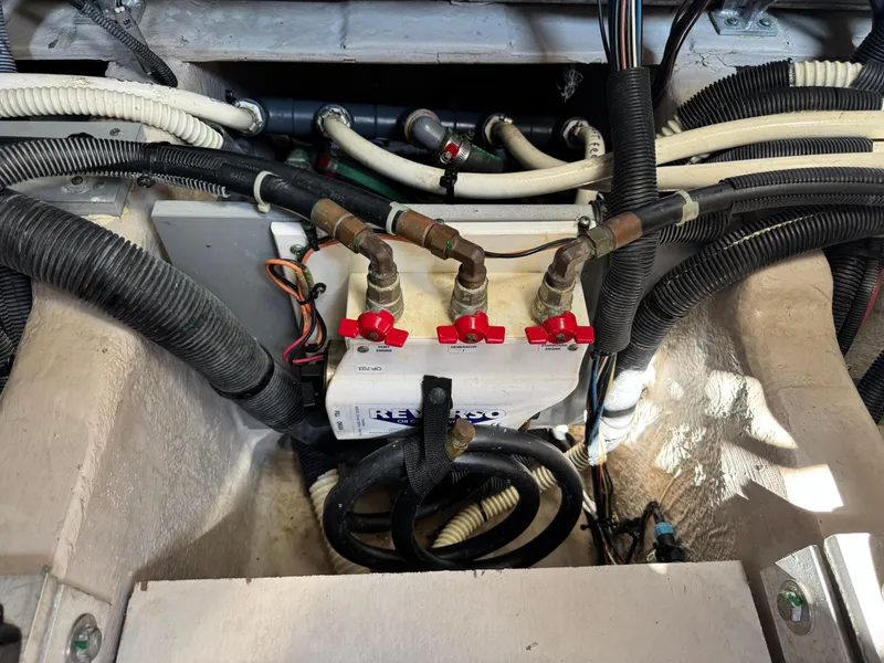 Slide: The Image of Engine compartment of a 2014 Sea Ray 510 Sundancer with hoses and valves. - 44