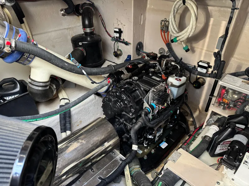 Slide: The Image of Engine room of a 2014 Sea Ray 510 Sundancer, showcasing complex mechanical components and wiring. - 46