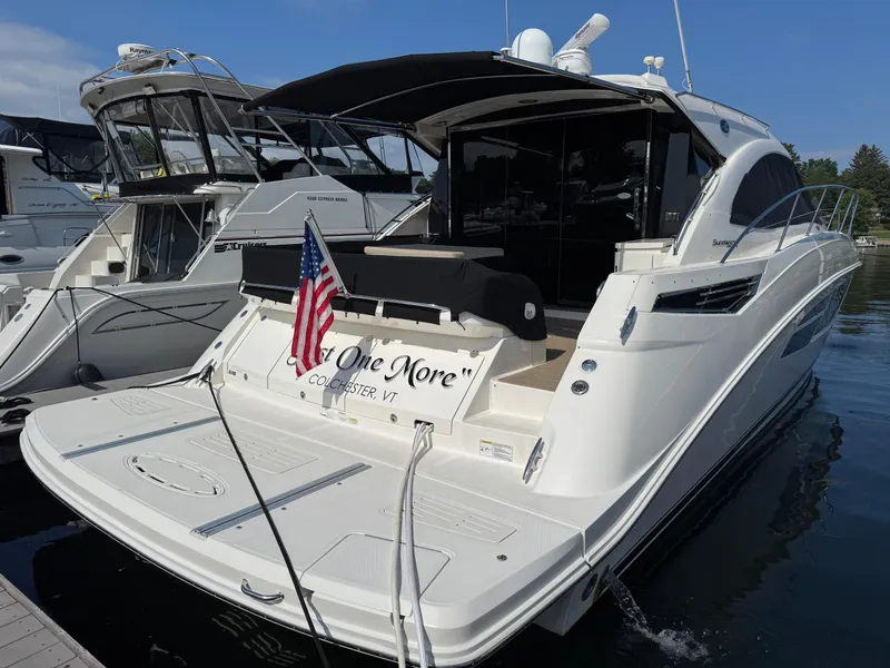 Slide: The Image of 2014 Sea Ray 510 Sundancer yacht docked, displaying an American flag. - 5
