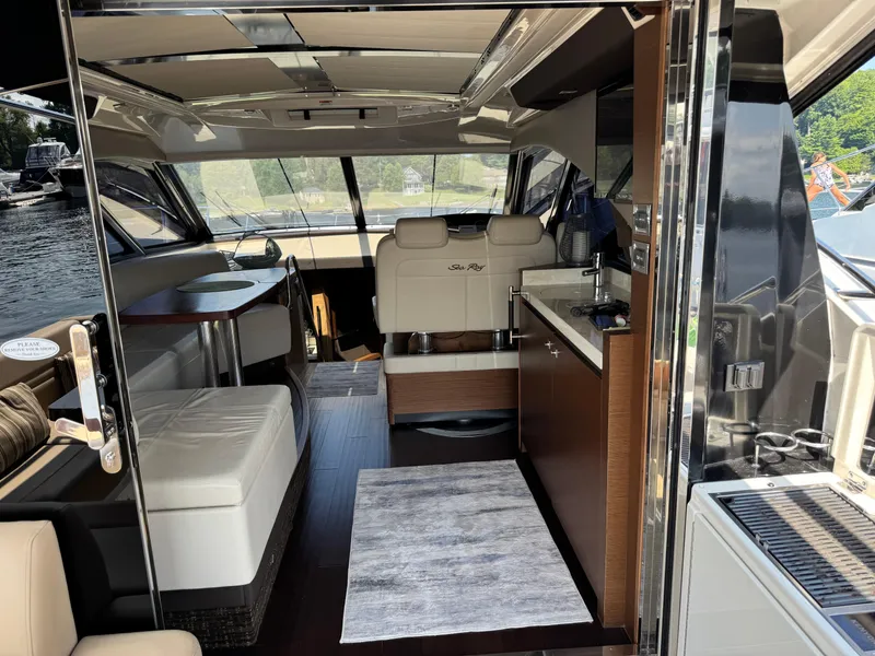 Slide: The Image of Luxurious interior of 2014 Sea Ray 510 Sundancer yacht with modern seating and kitchenette. - 9