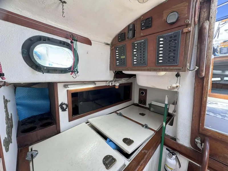 Slide: The Image of 1979 CSY 44 yacht interior with control panels and storage compartments. - 21