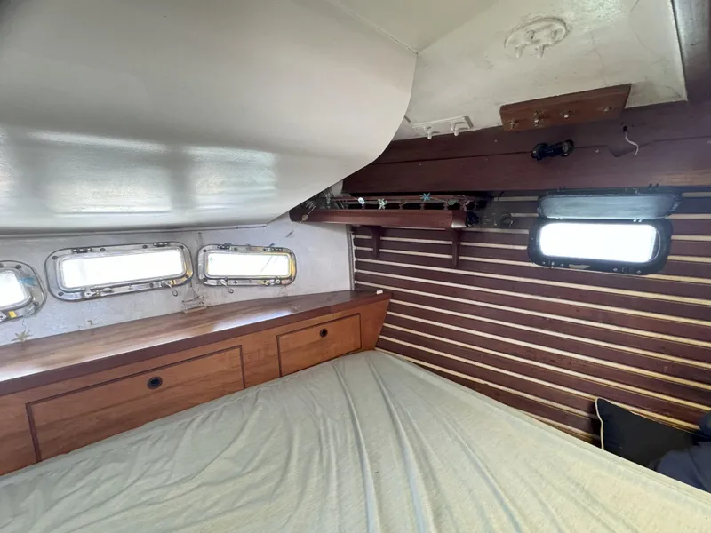 Slide: The Image of Cozy cabin interior of 1979 CSY 44 sailboat with wooden accents and porthole windows. - 26