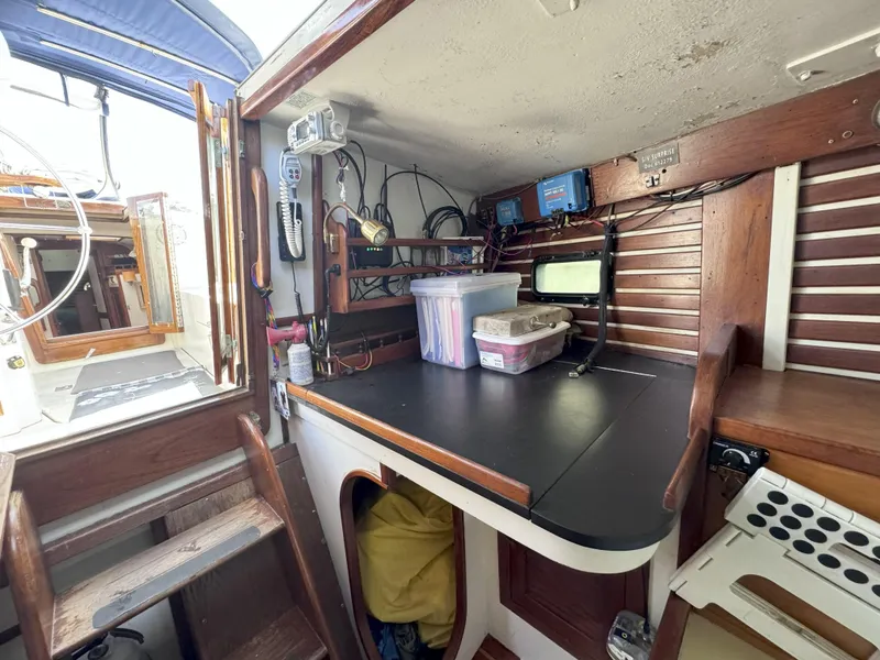 Slide: The Image of Interior of a 1979 CSY 44 sailboat with navigation equipment and storage. - 27